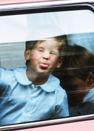 A young Prince Harry pulling faces at the paparazzi