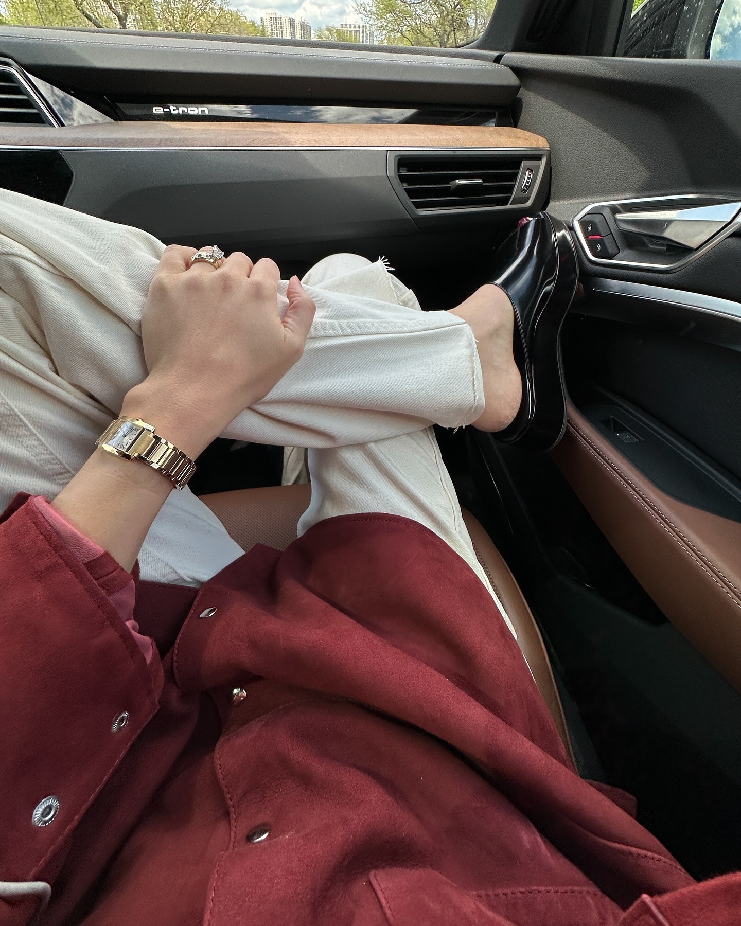 Ilana wears the row remi slides, white jeans, and a red top.