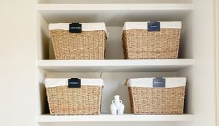 baskets with labels on in a decluttered bathroom