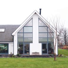 house with white wall and garden area