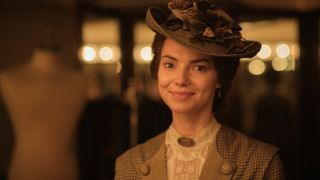 Kara Tointon in a brown hat and jacket as Elsie Leach in Archie
