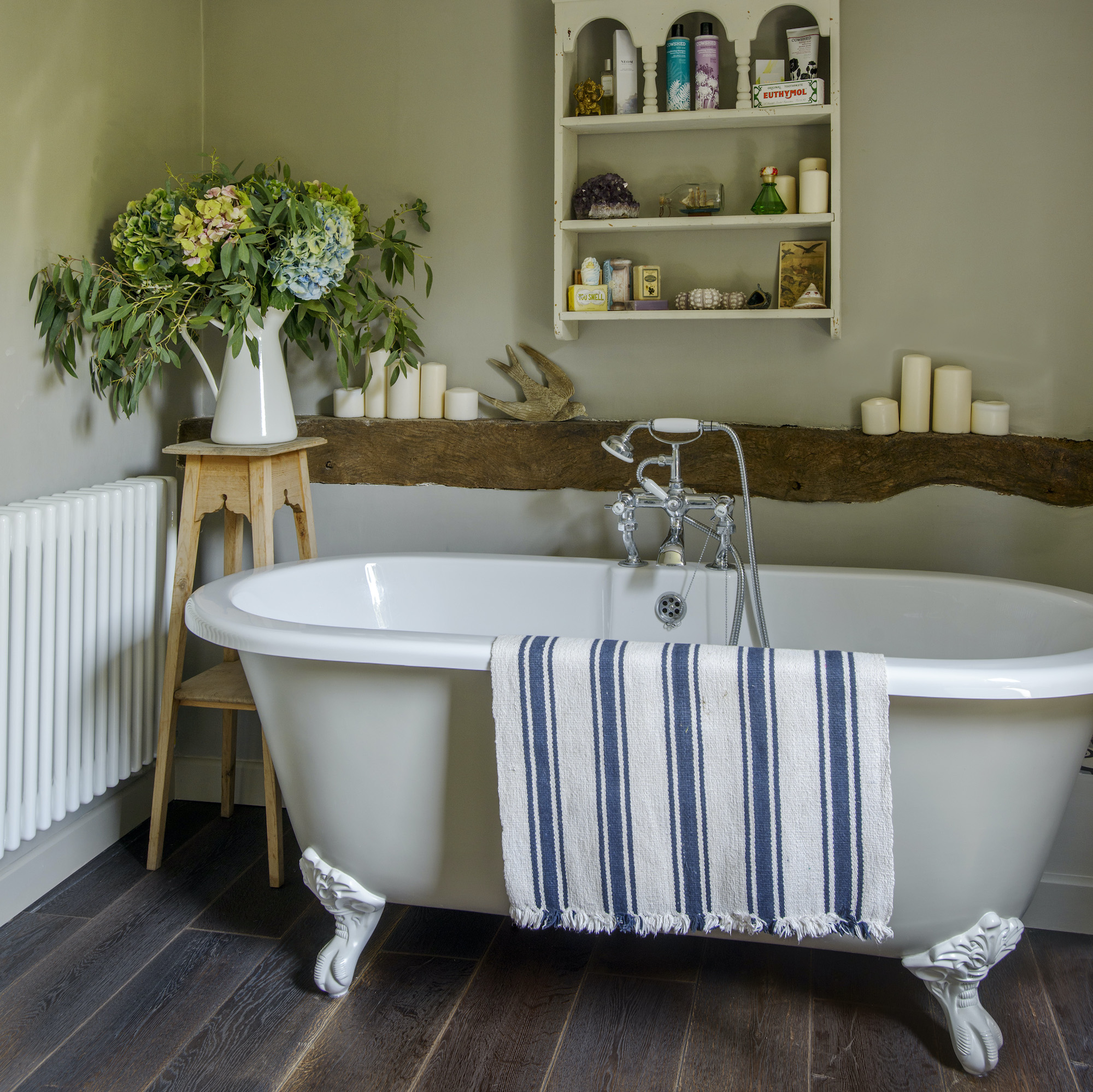 roll top in green  bathroom with wood floors