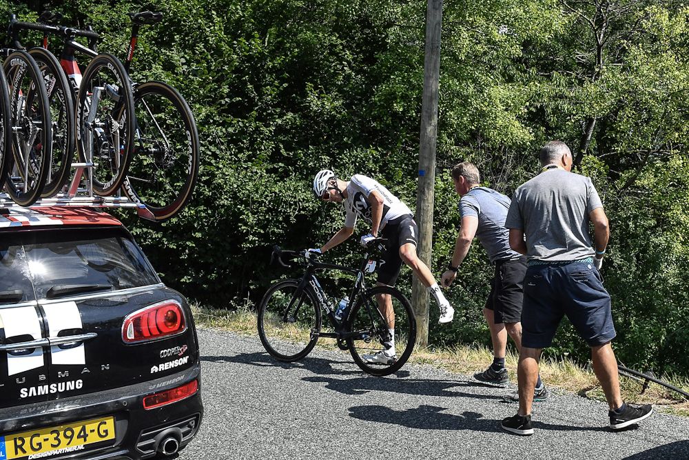 Chris Froome remounts after a puncture during stage 10 at the Tour de France