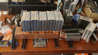 A homemade passive GPU cooler, comprising a large copper slab and several heatsinks.