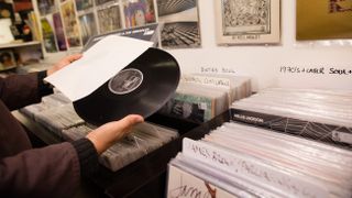 A picture of a man browsing the vinyl in a record store