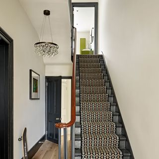 hallway with upstairs and carpet