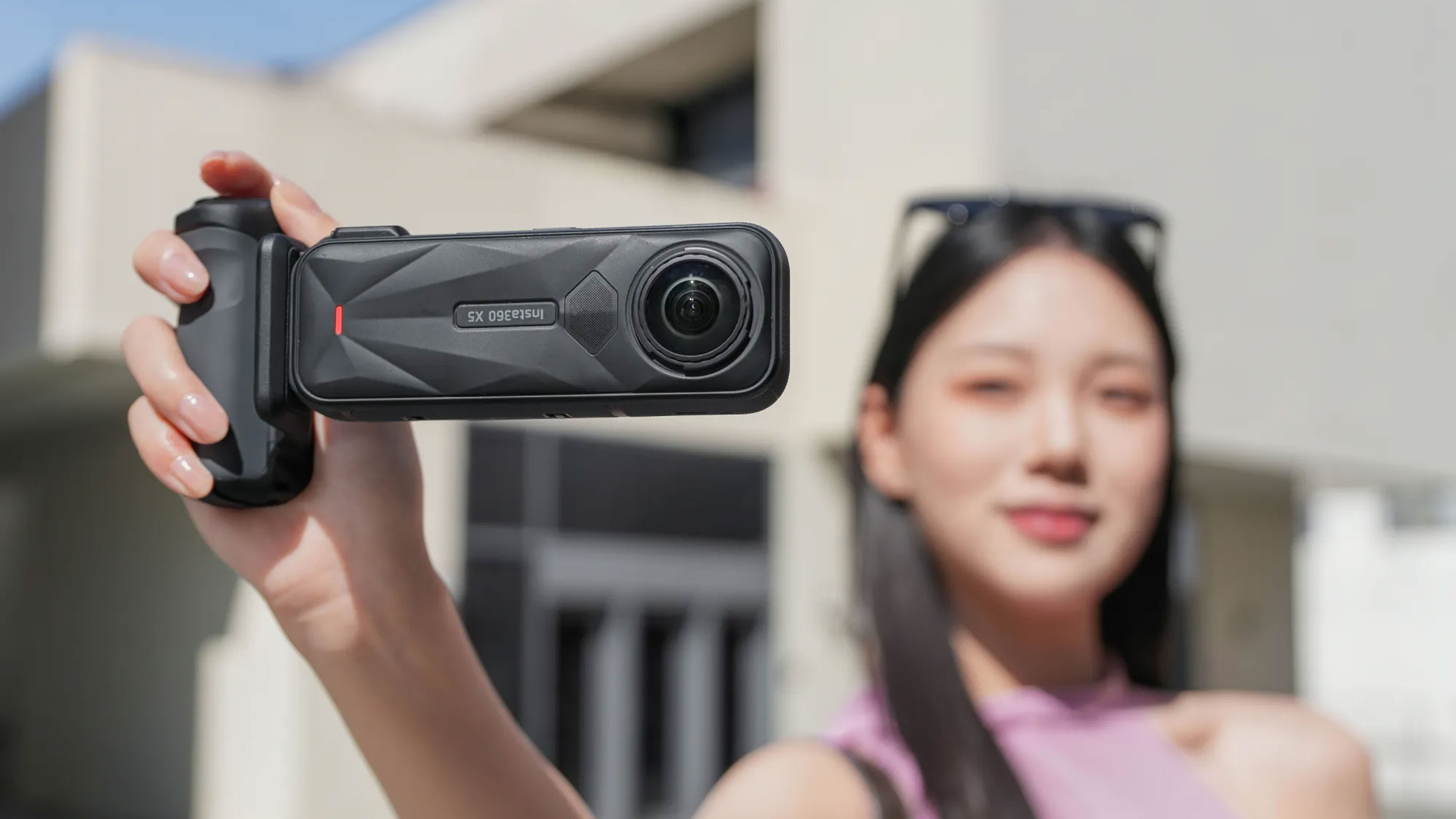 Person holding Insta360 X5 camera and X5 Photography Grip