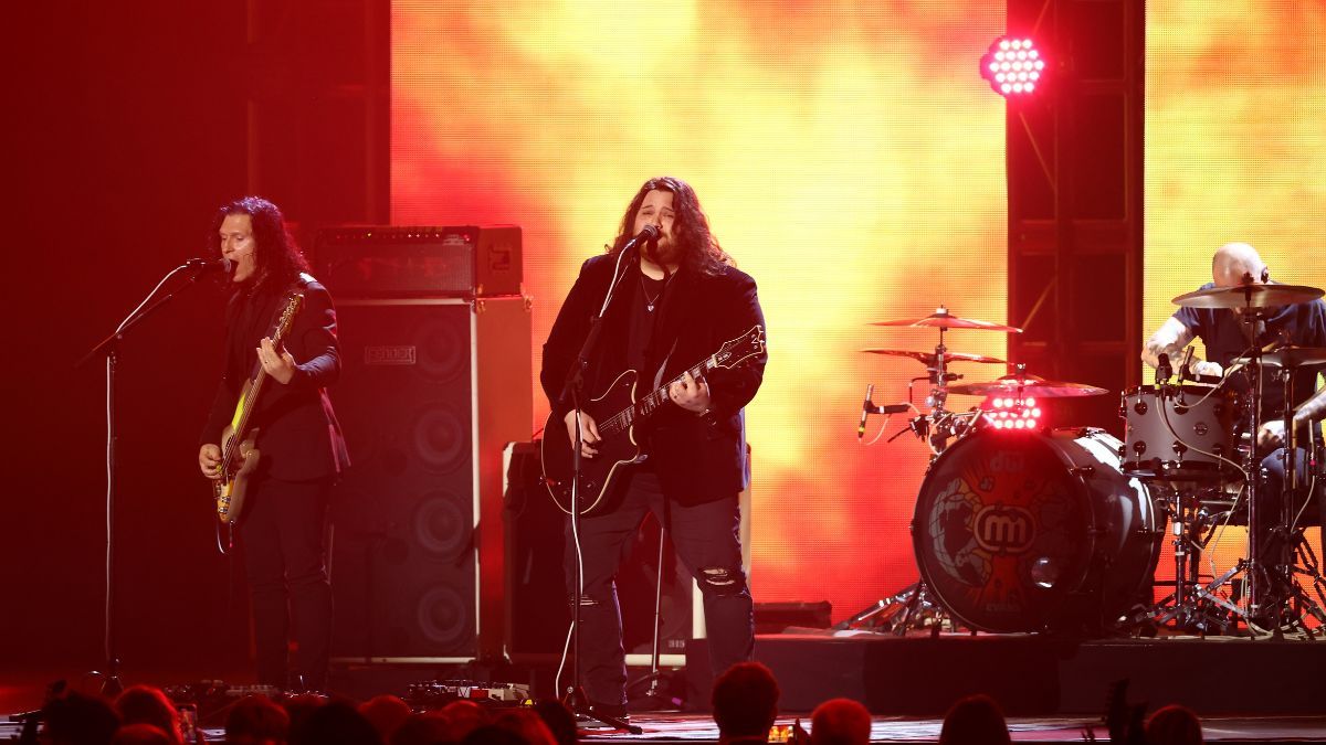 Wolfgang Van Halen playing guitar and singing on stage with Mammoth WVH