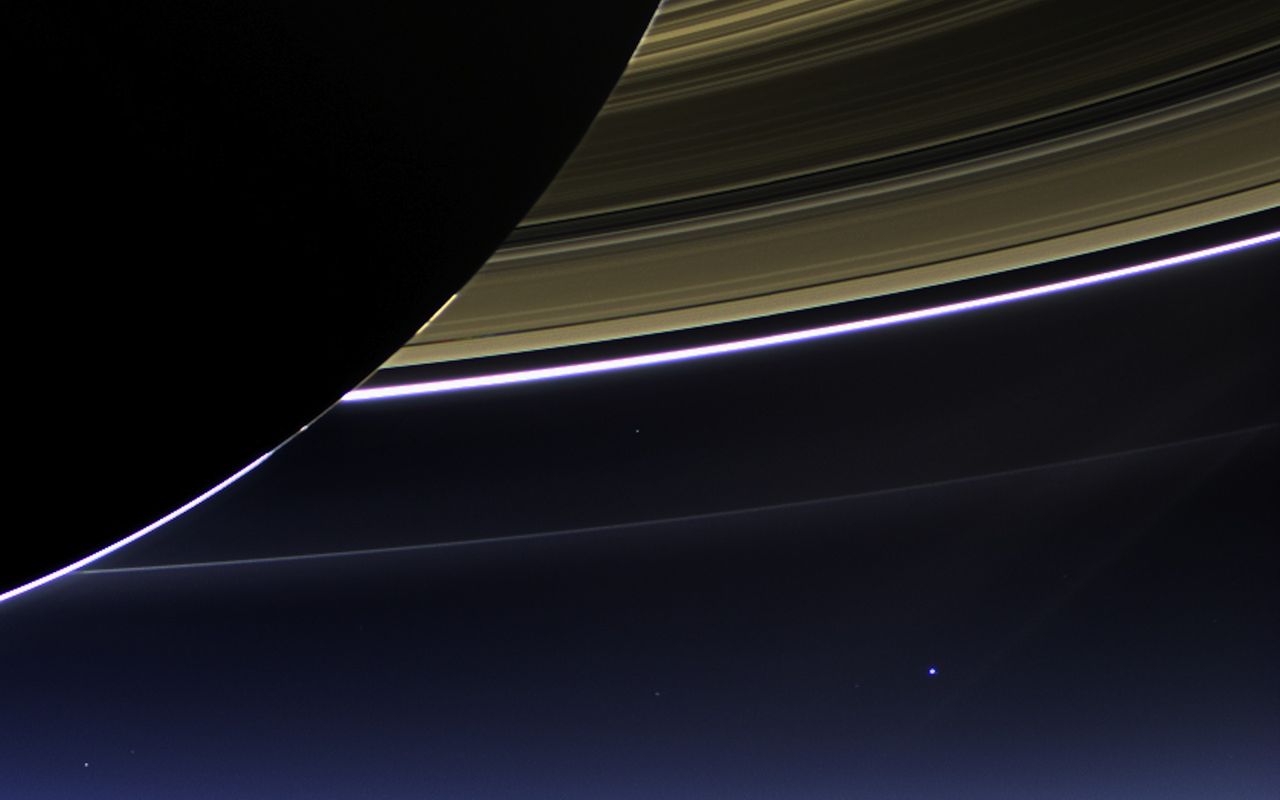This rare space wallpaper taken on July 19, by NASA's Cassini spacecraft shows Saturn's rings and our planet Earth and its moon in the same frame.