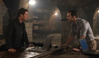 Tom Cruise and Henry Cavill argue over a table of laptops in Mission: Impossible - Fallout.