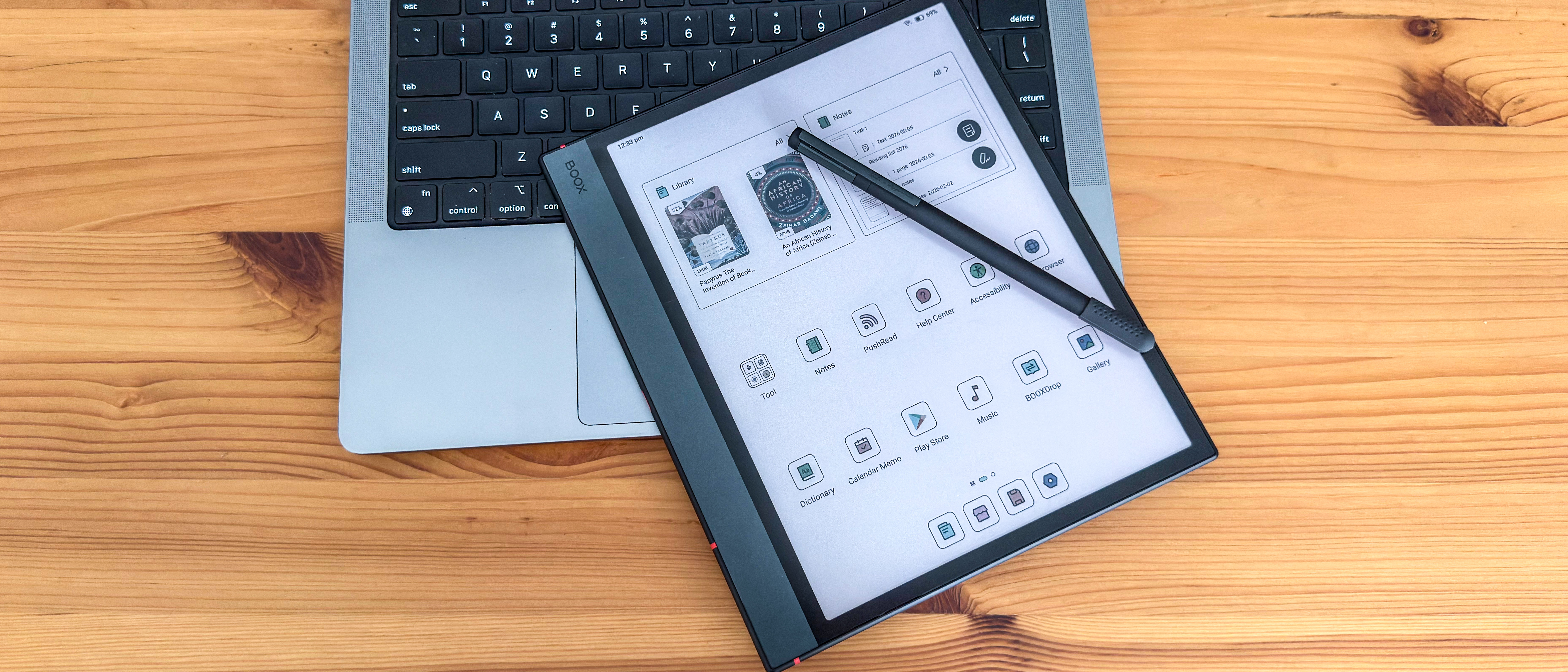 The home screen displayed on the Boox Note Air5 C with its Boox Pen 3 stylus on a laptop keyboard