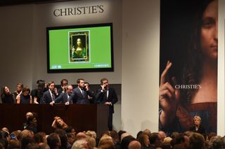 Christie's employees take bids for Leonardo da Vincis "Salvator Mundi" at Christie's New York on Nov. 15, 2017.