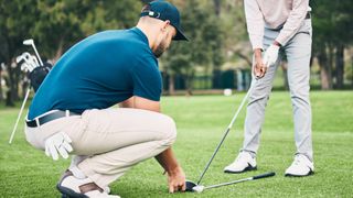 Golf pro giving pupil a lesson