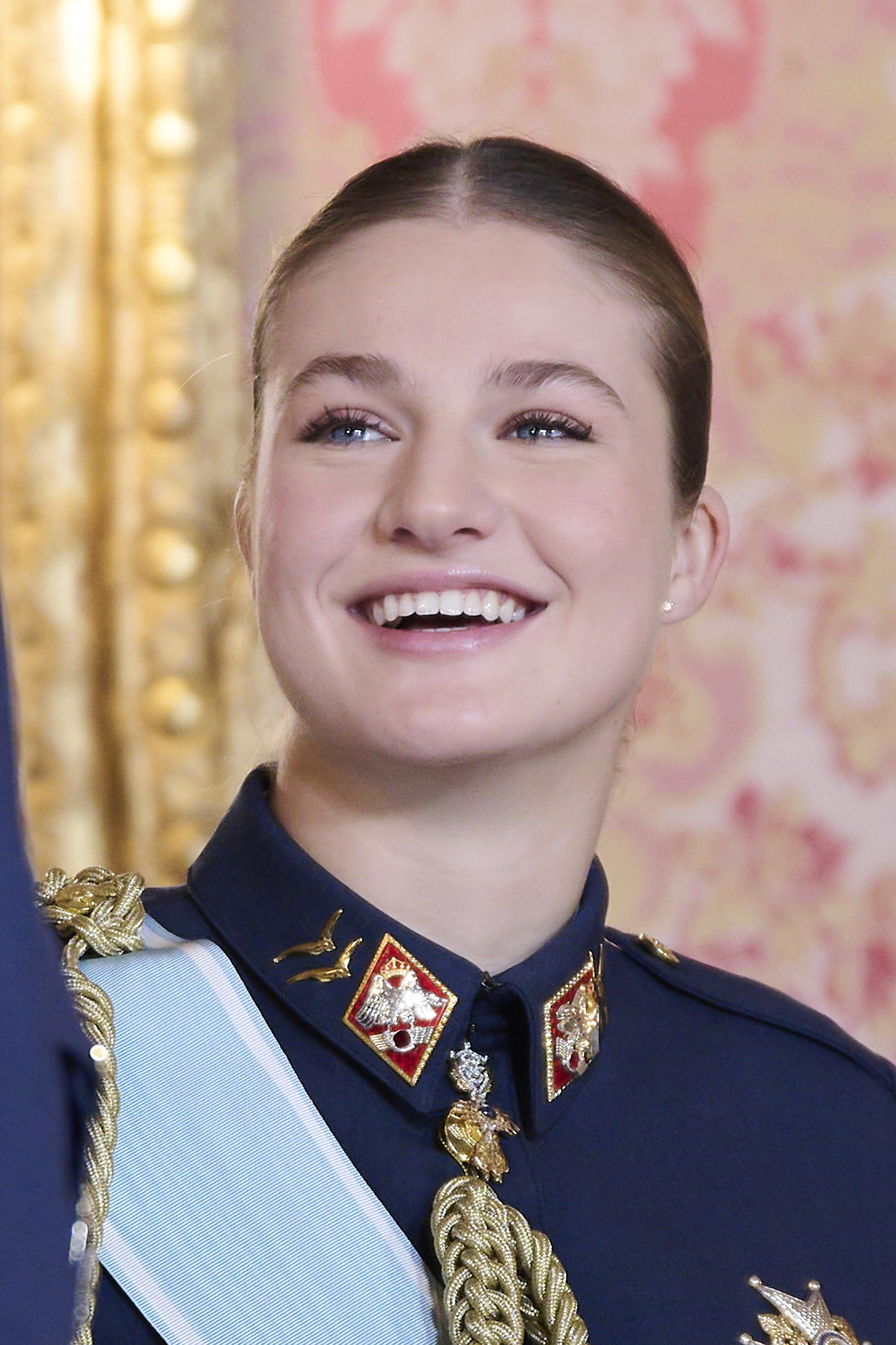 Princess Leonor smiling in a military uniform and pink makeup