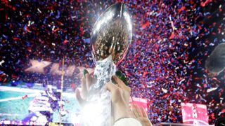 The Super Bowl trophy being lifted