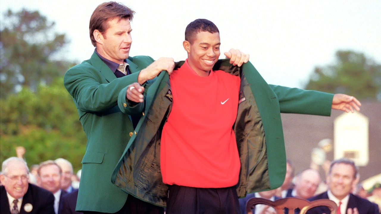 Nick Faldo presents Tiger Woods with his first Green Jacket 