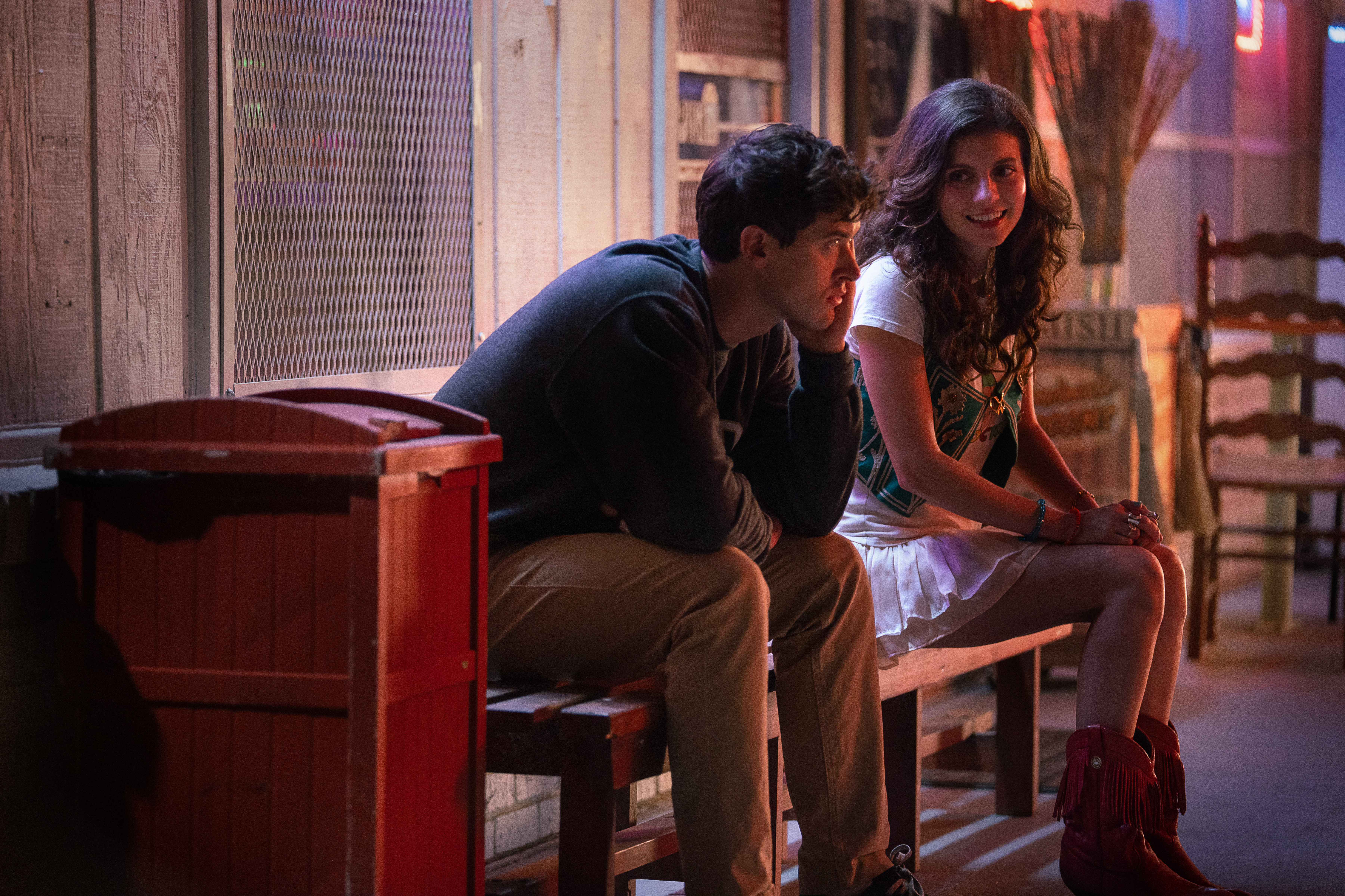 Alex and Poppy in People We Meet on Vacation driving home from college