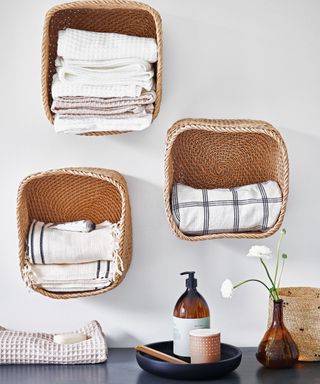 storage baskets on wall on bathroom wall