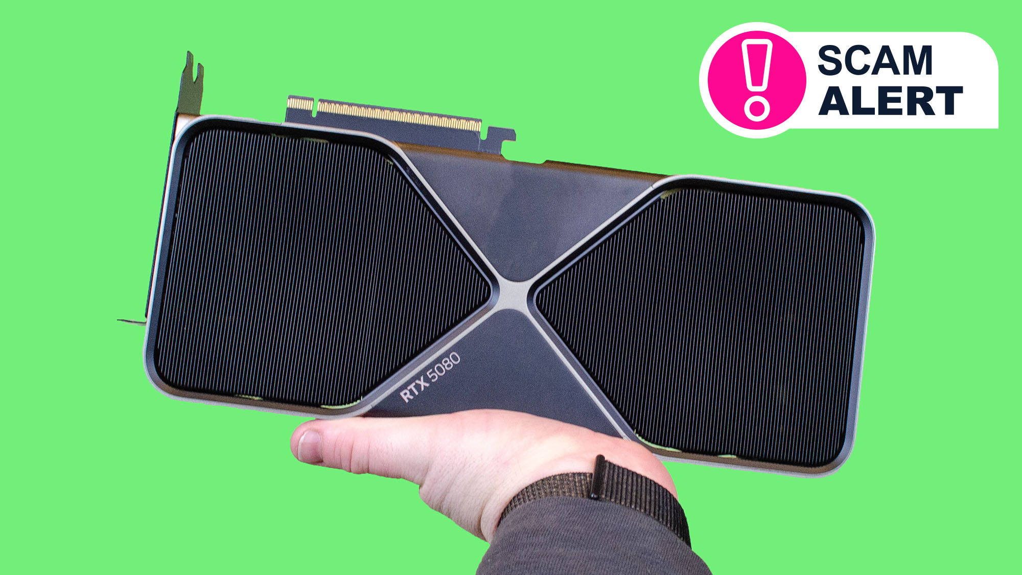 A hand holding an Nvidia RTX 5080 graphic card on a green background