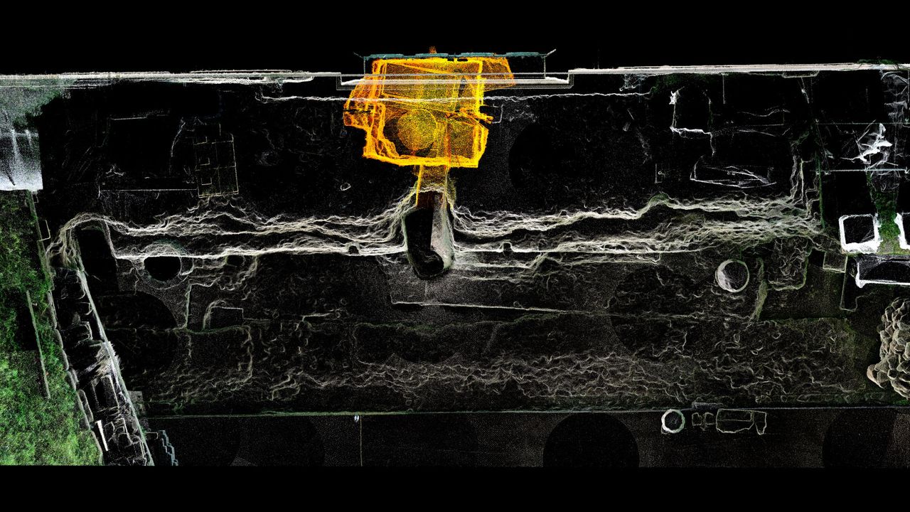 A 3D laser scan image showing the tomb, with its circular alter and rectangular stone sarcophagus, and parts of the buried Comitium, or assembly place.