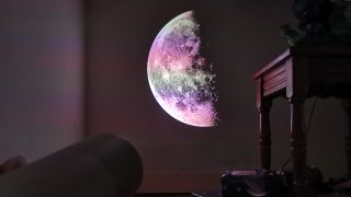 The XGIMI MoGo 4 Laser projector set-up with various accessories.