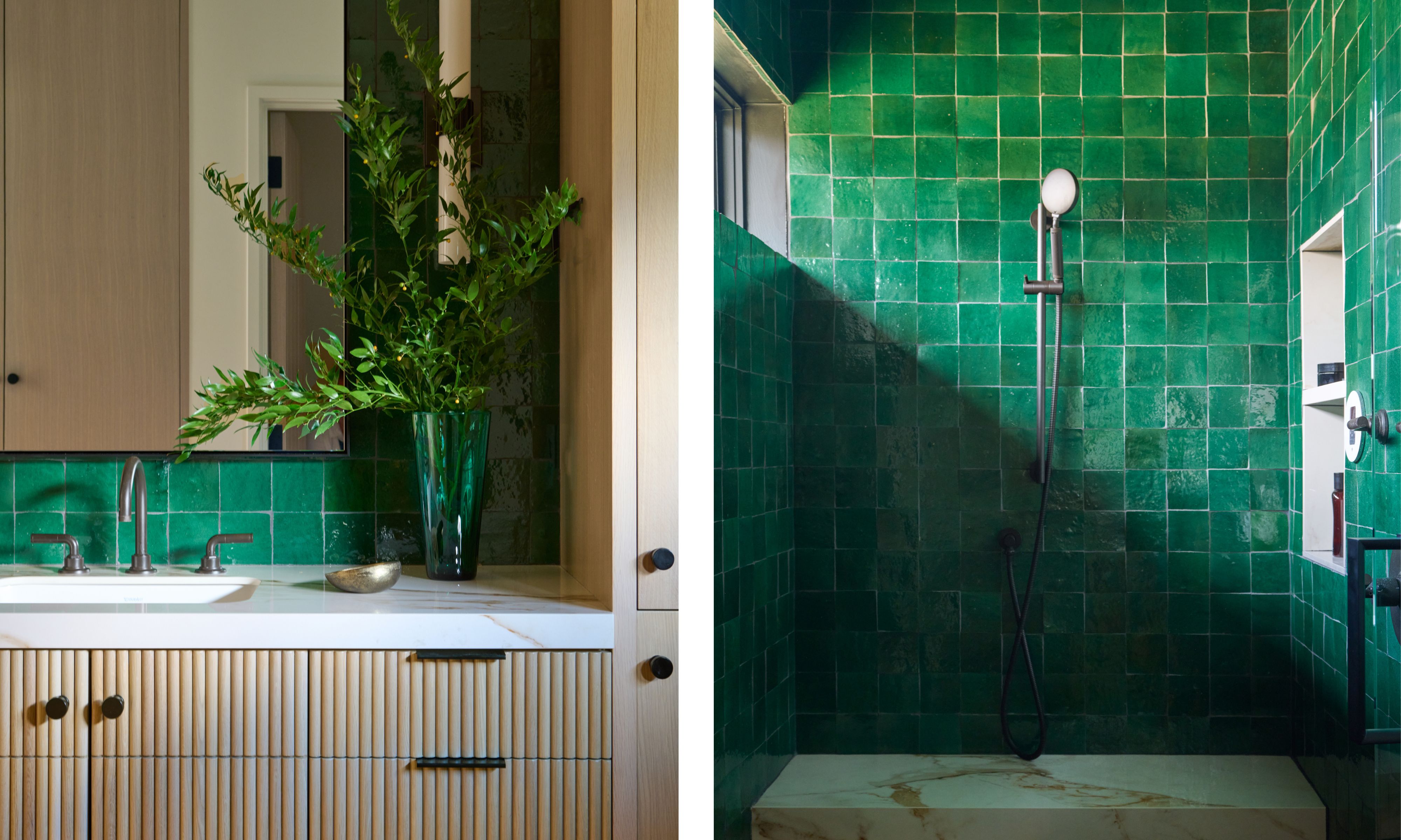 Left image: A vanity setup with a light wood fluted cabinet featuring black hardware. Above it, green square glossy tiles create a bold backsplash. A tall green glass vase with leafy branches sits on the side and a large simple mirror hangs above. Right image: A walk-in shower fully clad in glossy green square tiles. It features a simple black handheld showerhead and a recessed shelf with bath products. The built-in bench is topped with a marble slab.