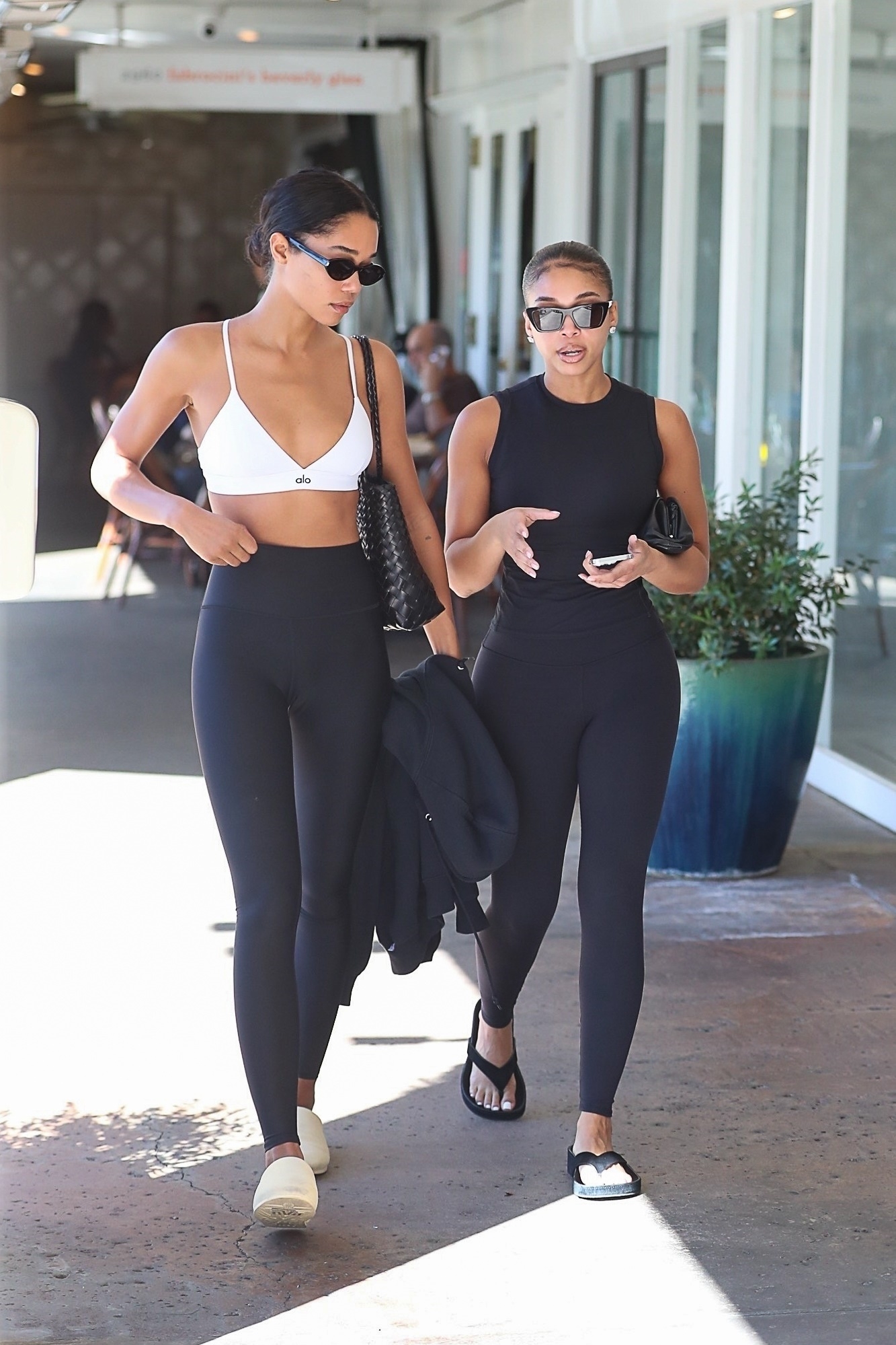 Lori Harvey and Laura Harrier enjoy brunch at Jayde's Market after a joint Pilates class wearing black leggings.