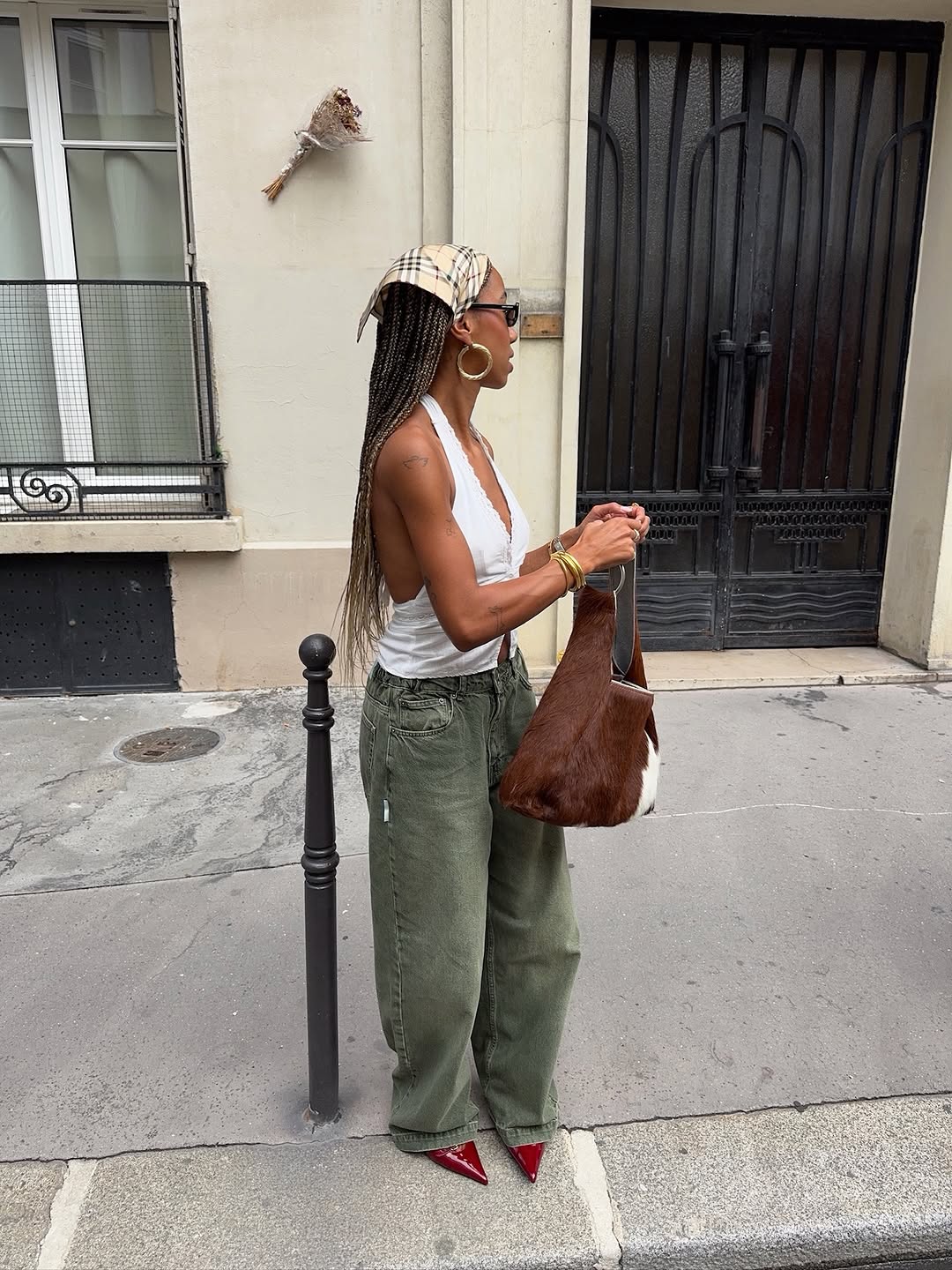 An image of woman wearing triangle headscarf, one of the biggest early summer 2026 micro trends.