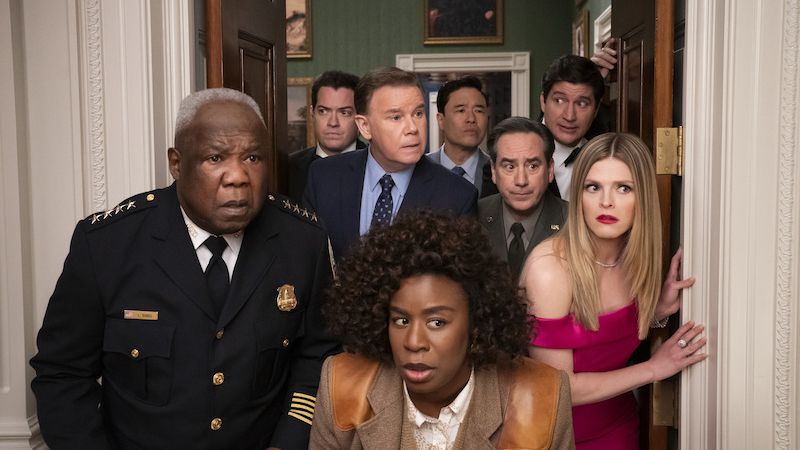 L-R: Isiah Whitlock Jr., Dan Perrault, Spencer Garrett, Uzo Aduba, Randall Park, Andrew Friedman, Ken Marino, Molly Griggs peak around a doorway in a still for Netflix&#039;s &quot;The Residence&quot;.