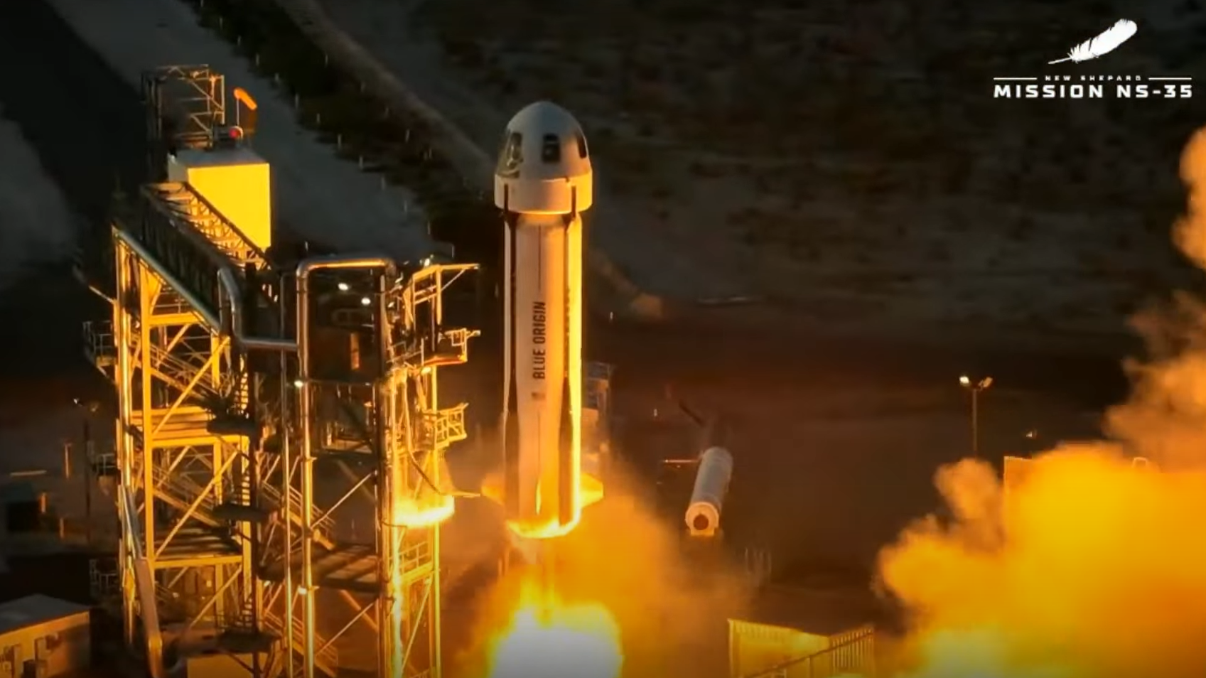 a white rocket topped by a gumdrop-shape capsule launches