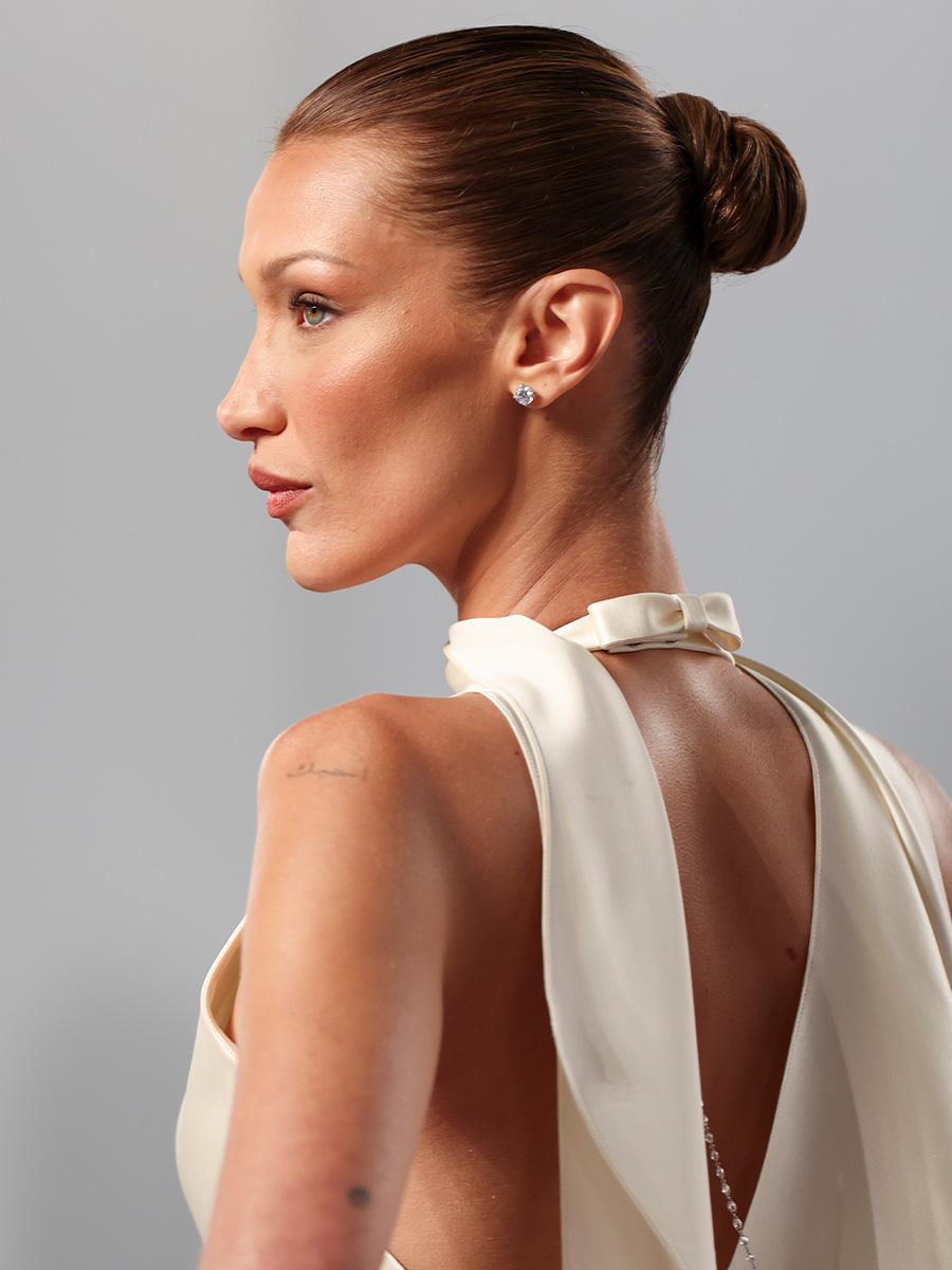 Bella Hadid at the 2026 Vanity Fair Oscar Party with a sleek, teak brown-colored bun