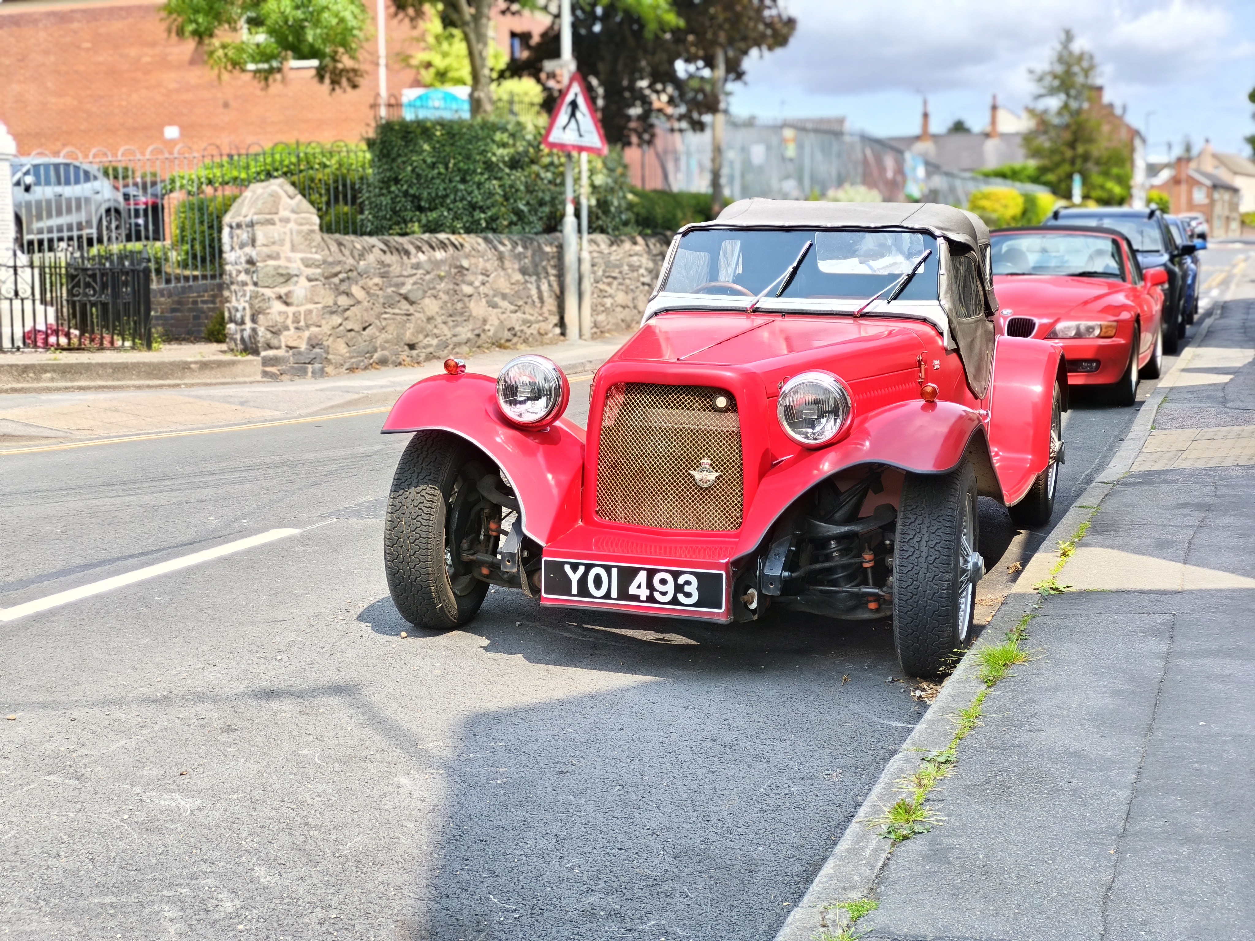 Red classic vintage car parked on a street