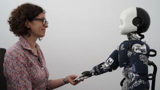 Study co-author Agnieszka Wykowska pictured with the deceptively "self-aware" robot iCub.
