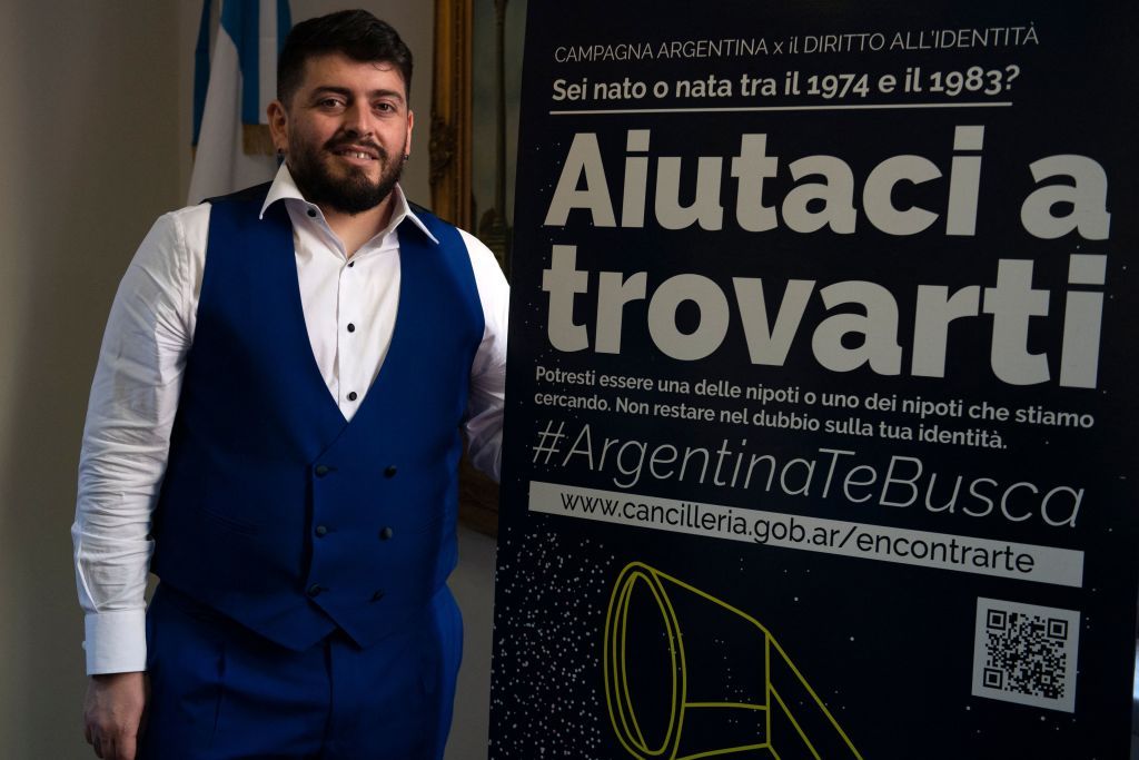 The Italian son of the late football idol Diego Maradona, Diego Armando Maradona Sinagra, known as Diego Junior, poses by a poster of an International Campaign for the Right to Identity, after he was granted the Argentine nationality on March 25, 2021 during a ceremony at the Argentine consulate in Rome. - Diego Junior is joining the International Campaign for the Right to Identity which helps search for the children stolen by the Argentinian dictatorship from their missing parents, and helps Italians who have had links with Argentina between 1974 and 1983 and who have doubts about their identity. The poster reads :
