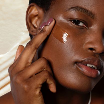 Woman applying clear SPF