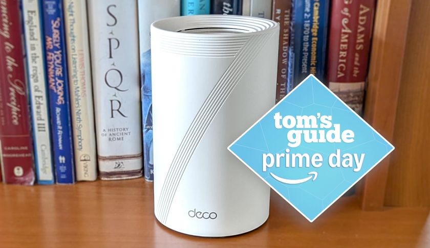 A TP-Link Deco BE63 Wi-Fi 7 mesh router on a bookshelf with a Tom&#039;s Guide Prime Day deals badge
