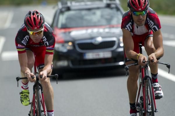 Defending Tour champion Cadel Evans, left, puts in some time on the time trial bike in Liege, Belgium.