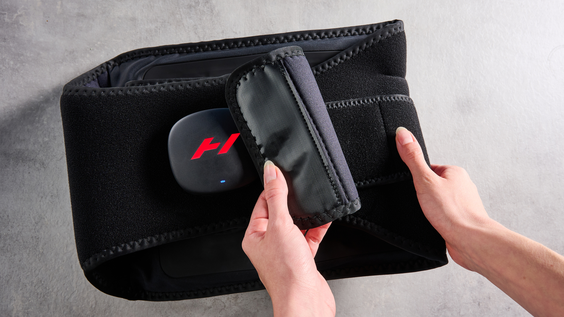Hyperice Venom 2 Back being worn by a woman photographed in front of a ble background