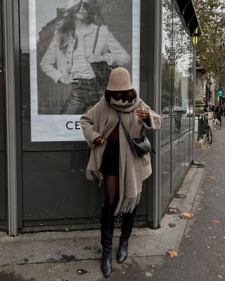 What to wear in November: @aidabadji wears a scarf coat with a mini skirt and knee-high boots