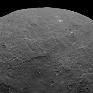 Dwarf planet Ceres contains a pyramid-shaped mountain estimated to rise about 3 miles (5 kilometers) above the surface. NASA's Dawn spacecraft took this image from an altitude of 2,700 miles (4,400 kilometers) on June 6, 2015.