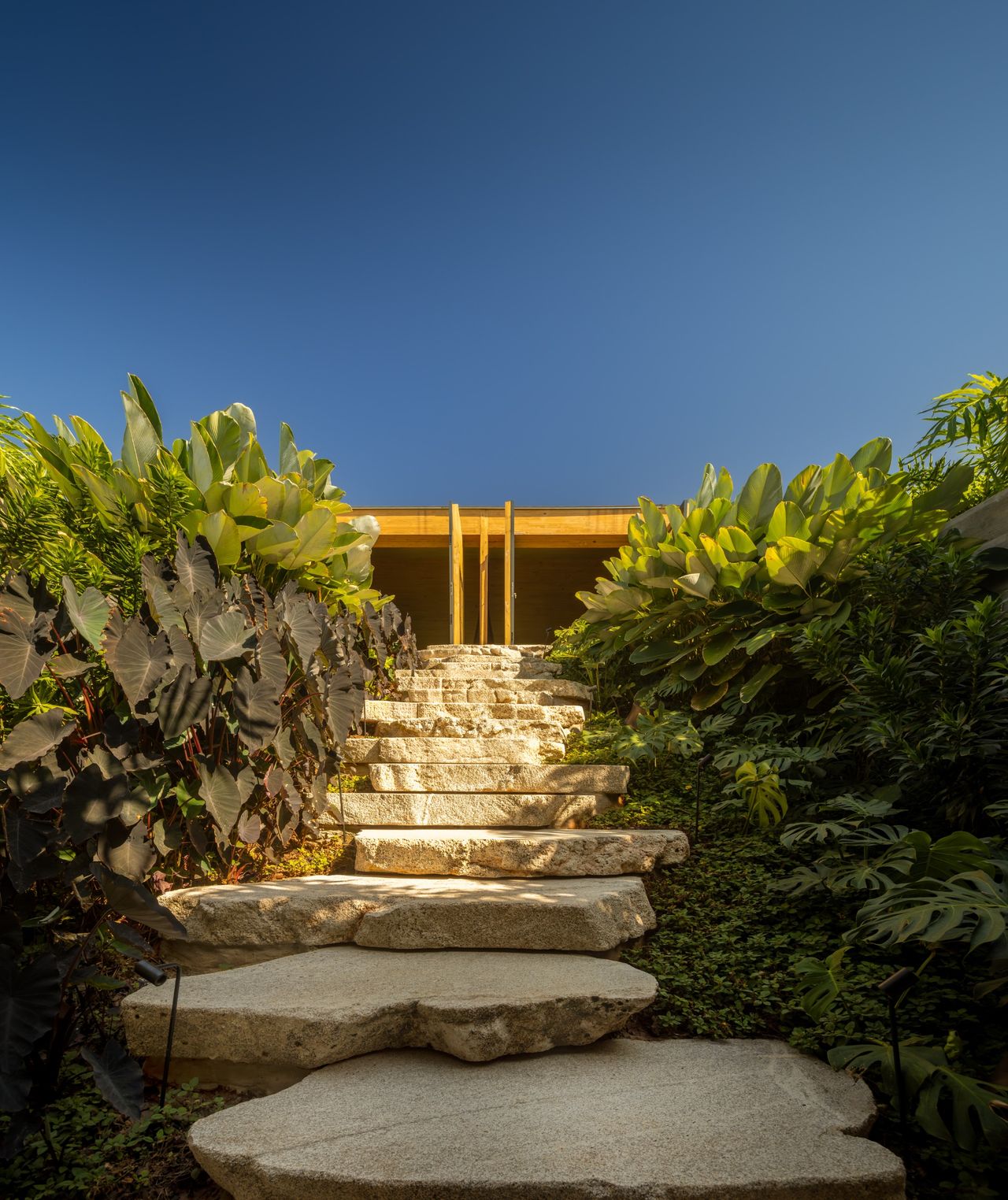 Stone steps lead down to the lower level