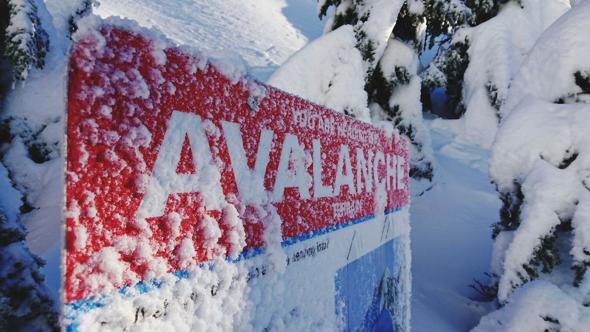 Avalanche sign with snow