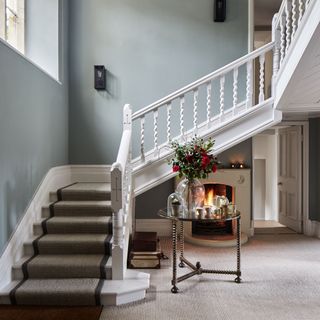 staircase with carpet and fireplace