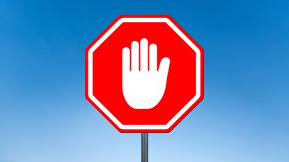 A white hand in the stop gesture on a red stop sign.