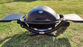 Weber Q1200 portable gas grill being tested in writer's home