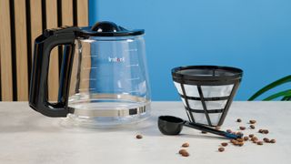 A black Instant Infusion Brew 12-Cup drip coffee maker with a removable water reservoir, glass carafe and reusable coffee filter