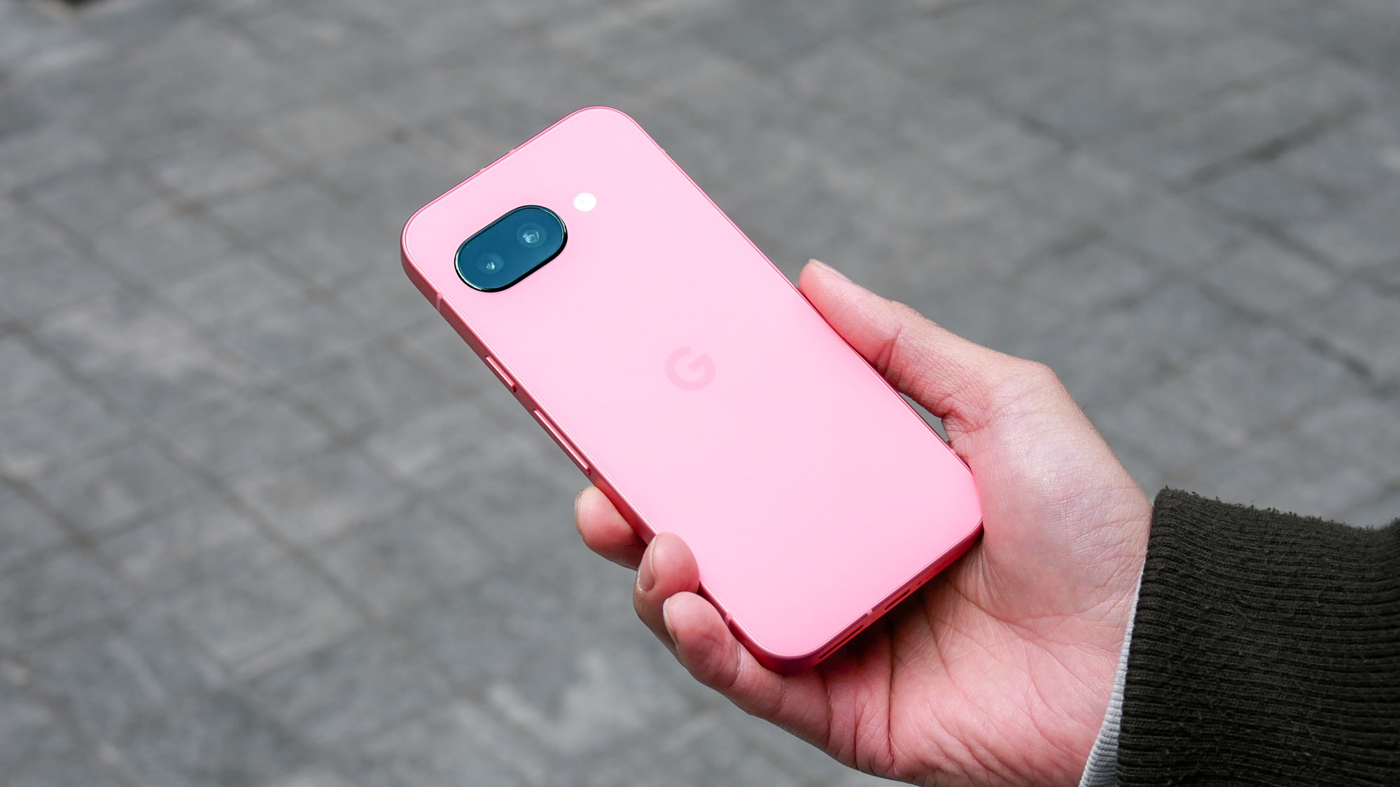 Google Pixel 9a held in the hand.