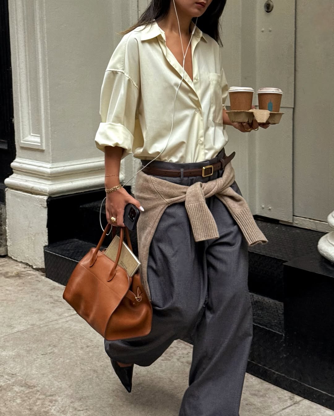 Caroline in a yellow shirt and grey trousers