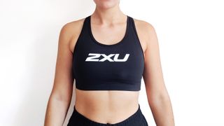 Woman wearing black 2Xu sports bra