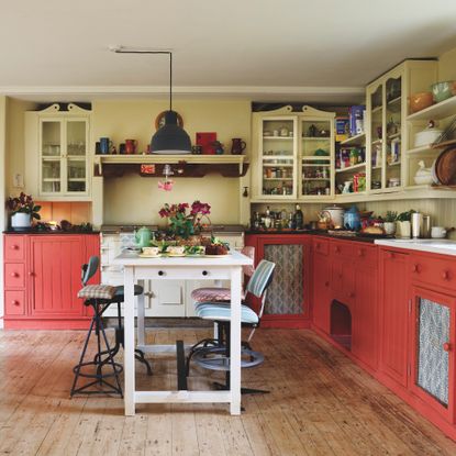 kitchen with peach painted cabinets and white island unit